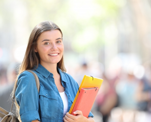 Student posing smiling in the street
